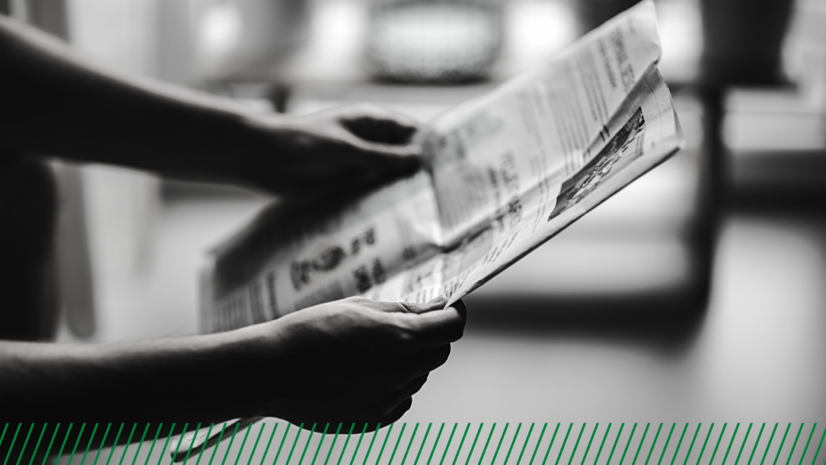 Person holding newspaper